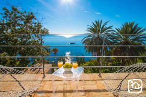 a view of the ocean from the balcony of a house at El jardin Botánico Villa LUZ in Altea