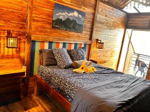 a bedroom with a bed in a room with wooden walls at B & B MAGGY_BEACH in Playa Blanca