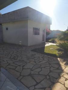 a house with a stone patio in front of it at Quitinete para casal in Brasília
