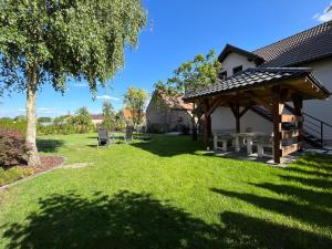 a pavilion with a picnic table in a yard at Noclegi u Alicji in Gołuchów +22 photos