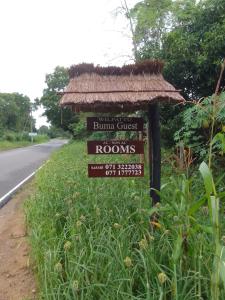 a sign for a building on the side of a road at Wilpattu Buma Homestay in Pahala Maragahawewa