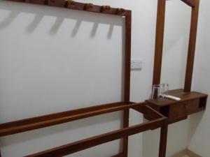 a mirror on a wall with a wooden shelf at Wilpattu national park forest buma lodge in Pahala Maragahawewa +83 photos