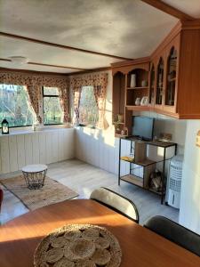 a living room with a table and a kitchen at tiny house in Saint-Vallier