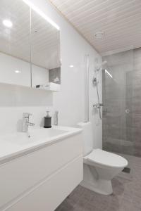 a white bathroom with a toilet and a sink at New LUXUS 3BR Helsinki Home in Helsinki