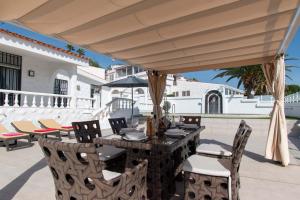 a table and chairs under an umbrella on a patio at Villa Chayofa in Chayofa