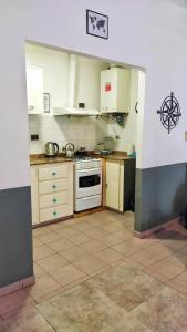 a kitchen with white cabinets and a stove at Centro II in Venado Tuerto