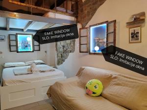 a small bedroom with two beds and a sign that reads fake windowskip windowskip at Traditional Piran studio in Piran