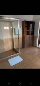 a bathroom with a glass shower with a door at KingdomHomes. in Kigali