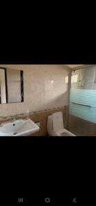 a bathroom with a toilet and a sink at KingdomHomes. in Kigali