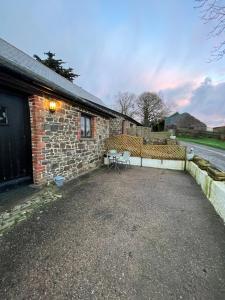 a patio of a brick building with a table and chairs at Immaculate 1-Bed Cottage in Bideford in Bideford