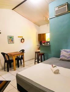Zimmer mit einem Bett, einem Tisch und Stühlen in der Unterkunft Eco chalés 1 e 2 in Cabo de Santo Agostinho
