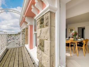 a balcony with a table and a dining room at The Penthouse Westhaven Aberdyfi in Aberdyfi