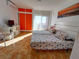 a bedroom with two beds and a tv in it at Agata Views in Benalmádena