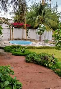 a swimming pool in the yard of a house at Casa de Praia em Pirangi in Nísia Floresta