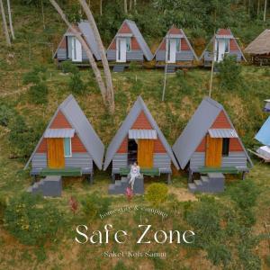 a group of cottages with a person sitting in front at SZ Samui Glamping in Ban Sa Ket