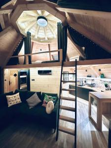 a room with a bunk bed and a ladder at Heavenly Houses - Niebiańskie Domki in Jaworzynka