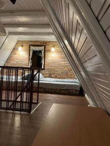 an attic room with a bed in a brick wall at Holiday house Zmajevac (Tornik, Zlatibor) in Zlatibor
