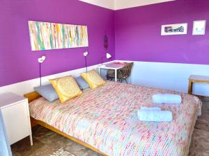 A bed or beds in a room at The Beachhouse Apartments