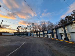 an empty parking lot in front of a building at Budget Inn - Roxboro in Roxboro