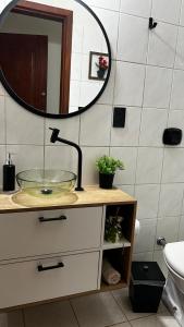 a bathroom with a glass sink and a mirror at Sunset Cacupé in Florianópolis