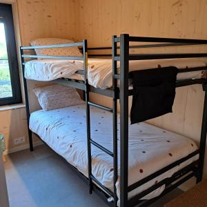 a couple of bunk beds in a room at Dunehuys in Koksijde