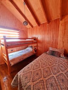 Säng eller sängar i ett rum på Cabañas Villa Elfo