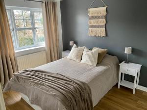 a bedroom with a bed and a window at 3 Bedroom House 2 stops from London Bridge in London