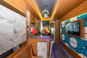 a kitchen with a sink and a tv in a room at mayza otel in Istanbul