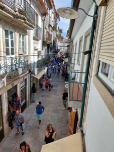 a group of people walking down a street at Fortaleza Faro in Valença