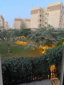 a view of a park in a city with buildings at Luxurious, fully furnished and well equipped apartment with modern amenities, stunning views, and convenient location for remote work or studying from home in Madinaty