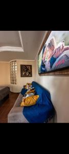a living room with a couch and a movie on the wall at Equilibrium Pousada Familiar (orquídeas) in Torres
