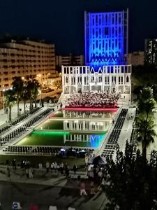 a building with a crowd of people in front of it at night at Casa Ginevra (appartamento 70mq ) in Taranto
