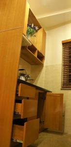 a kitchen with wooden cabinets and a counter top at Serviced Apartment next to the Hanoi Opera House Căn hộ đầy đủ tiện nghi có thang máy ngay gần Nhà Hát Lớn in Hanoi