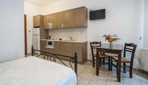 a kitchen with a table and chairs and a dining room at Elaida Apartments in Apollonia