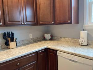 a kitchen with wooden cabinets and a counter top at Caddy Corner has a hot tub just outside of town in French Lick