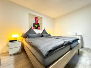 Un dormitorio con una cama grande con una imagen de superhéroe en la pared en Barockstadt-Apartment Rastatt, en Rastatt