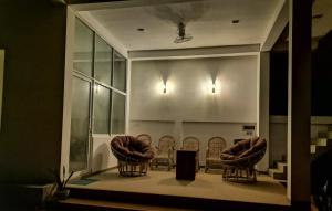 a group of chairs sitting in a room at Kottamba Yala Stay & Safari in Tissamaharama