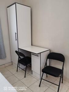 a desk and a chair in a room at Mosas Home in Serowe