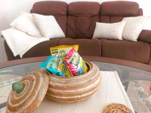 a bowl of chips on a glass table on a table at The Happy Retreat Villa in Belmont, Jamaica in Blue Hole