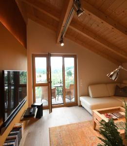 a living room with a couch and a table at Chalet Zauberberg in Zwiesel