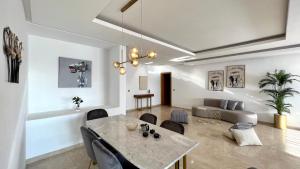 a living room with a table and a couch at Family 3 Bedrooms- By AppartAli in Casablanca