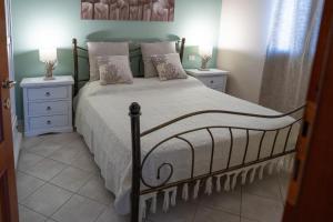 a bedroom with a large bed with two night stands at Residenza Piccolo Eden in Bosa Marina