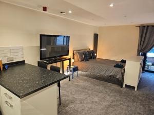 a hotel room with a bed and a television at Carlisle City Centre. The Annex. in Carlisle