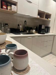 a kitchen with three cups sitting on a counter at Three Bedroom furnished apartment in north Riyadh in Riyadh