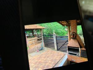 a view of a patio from a window of a house at Recanto Abadia in Ribeirão