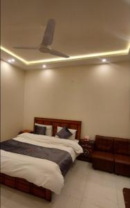 a bedroom with a bed and a ceiling fan at RADIANT GUEST HOuSE 2 in Islamabad