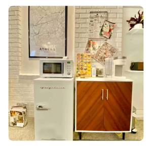 a white refrigerator with a microwave on top of it at Toadhaus Studio in quiet residential neighborhood ATHENS in Athens