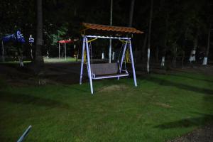 a swing in a yard with a canopy at amee's retreat in Diveagar