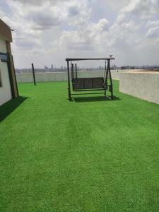 a bench sitting on top of a field of grass at Enzi heights in Nairobi