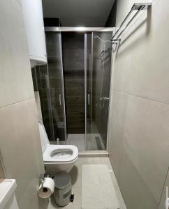 a bathroom with a toilet and a glass shower at SKY PEAK KRALJEVI ČARDACI APARTMENT in Kopaonik +5 photos